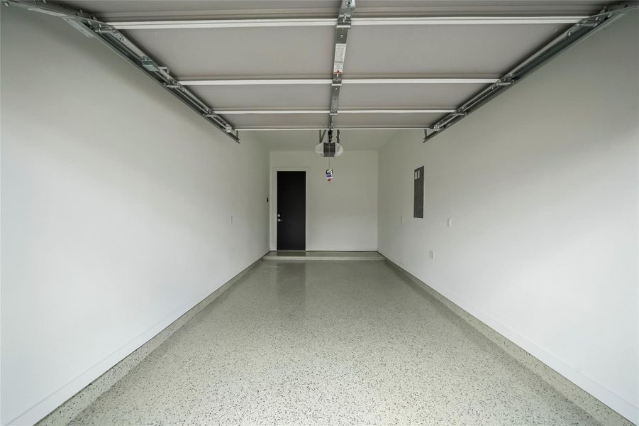 Experience the modern convenience of a sleek epoxy garage floor paired with an electric vehicle charging station. Experience the modern convenience of a sleek epoxy garage floor paired with an electric vehicle charging station.