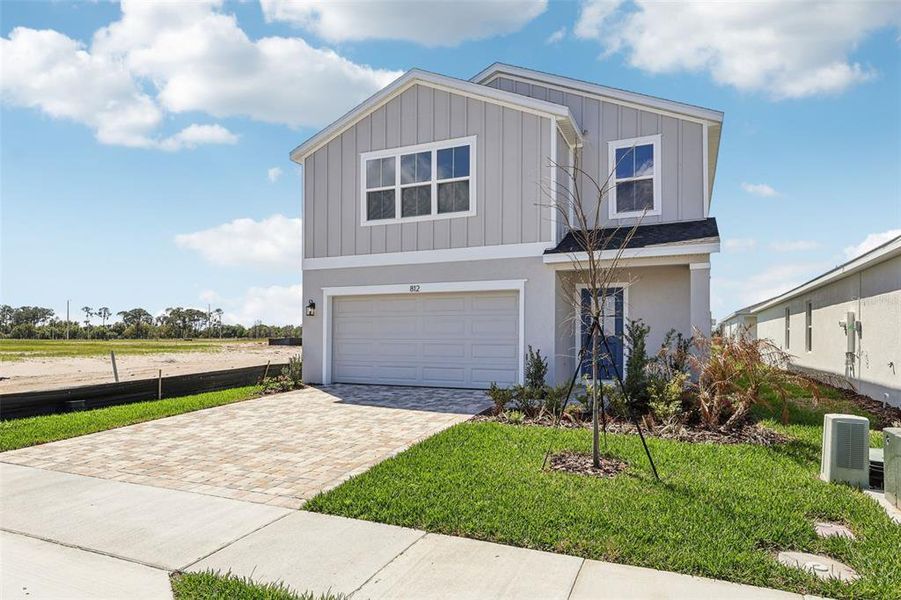 Front exterior of a new home in Willowbrook North, Winter Haven, FL, highlighting curb appeal (Image 2). Front exterior of a new home in Willowbrook North, Winter Haven, FL, highlighting curb appeal (Image 2).