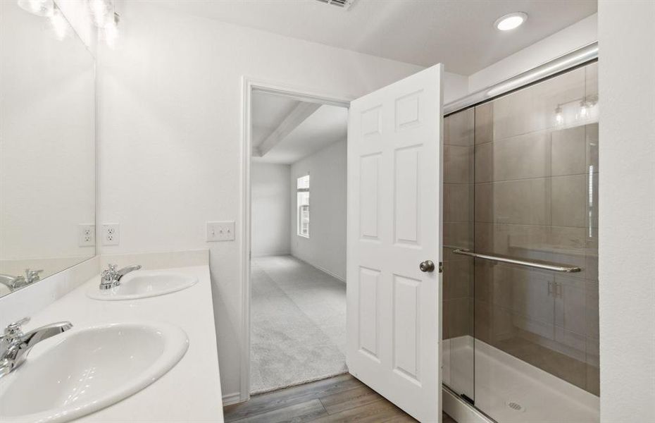 Owner's bath with dual vanity and oversized shower *real home pictured