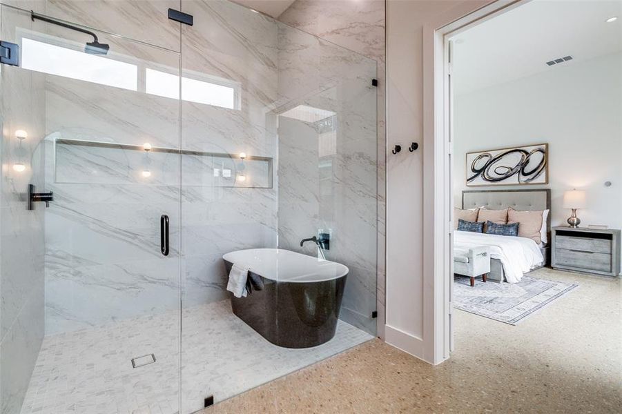 Bathroom with tile walls and a shower with door