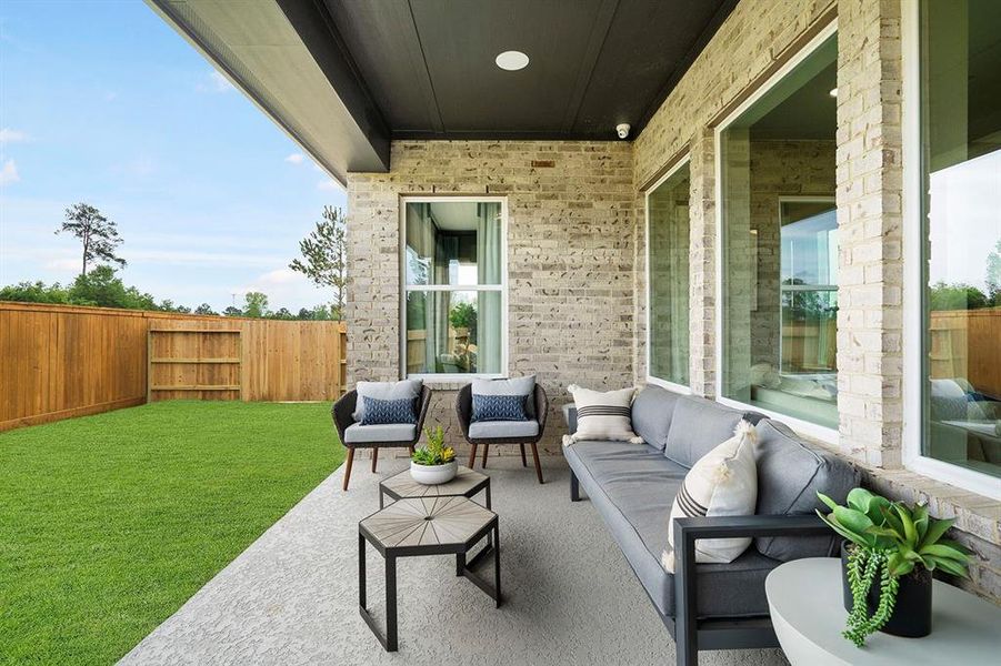 EXAMPLE PHOTO: Covered rear patio has a nice sitting area