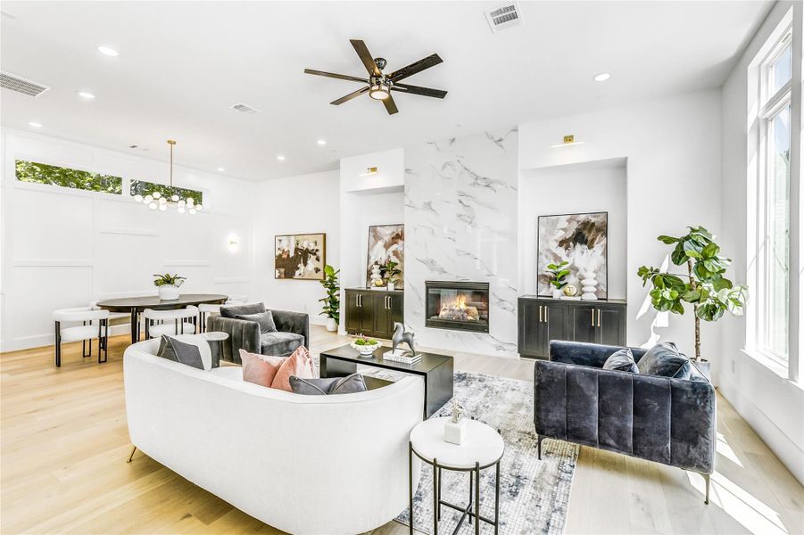 Step into the heart of the home where architectural elegance meets modern comfort. Soaring ceilings, oversized windows, and white oak flooring fill the open living and dining space with natural light. The seamless flow creates an ideal environment for hosting colleagues, relaxing after call shifts, or enjoying quiet evenings at home.