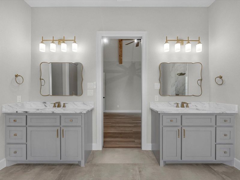 Dual vanities with quartz countertops, designer lighting, and refined details.