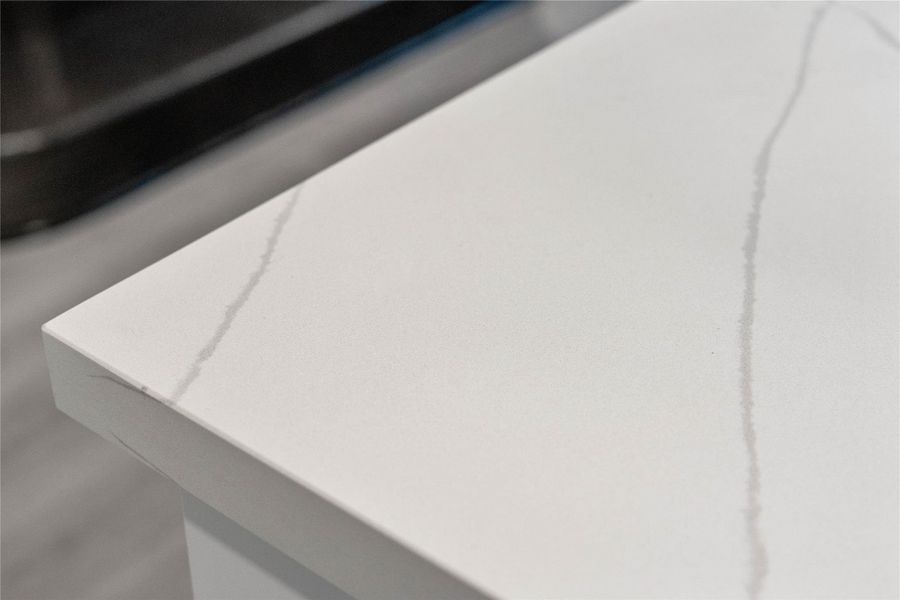 This striking quartz countertop combines the elegant, deep-veined look of natural stone with a highly durable, non-porous surface that is exceptionally resistant to scratches, stains, and daily wear. This striking quartz countertop combines the elegant, deep-veined look of natural stone with a highly durable, non-porous surface that is exceptionally resistant to scratches, stains, and daily wear.