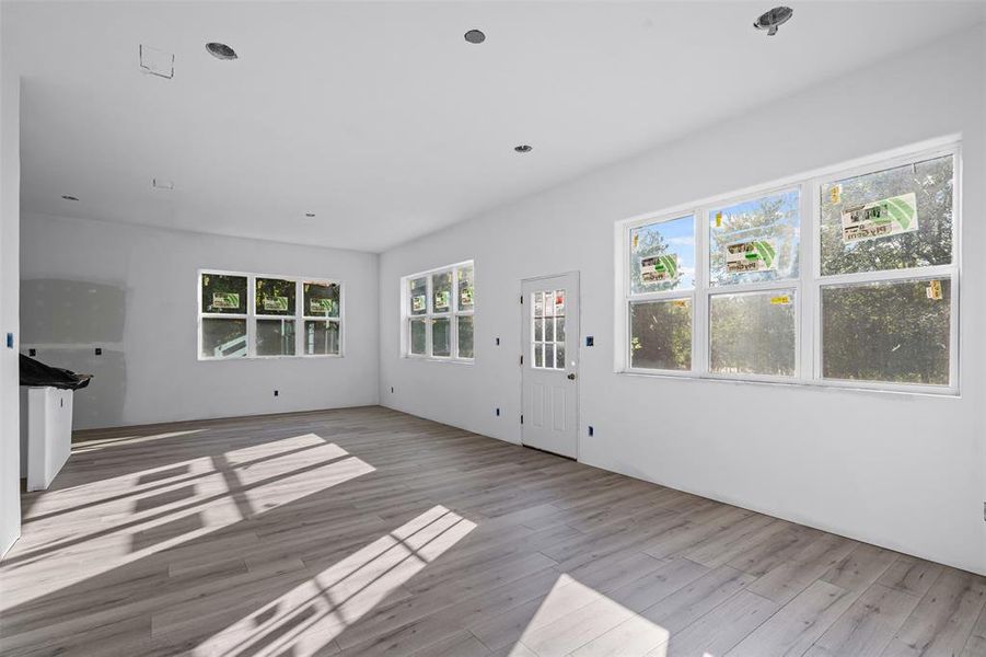 Unfurnished living room with wood finished floors and recessed lighting Unfurnished living room with wood finished floors and recessed lighting