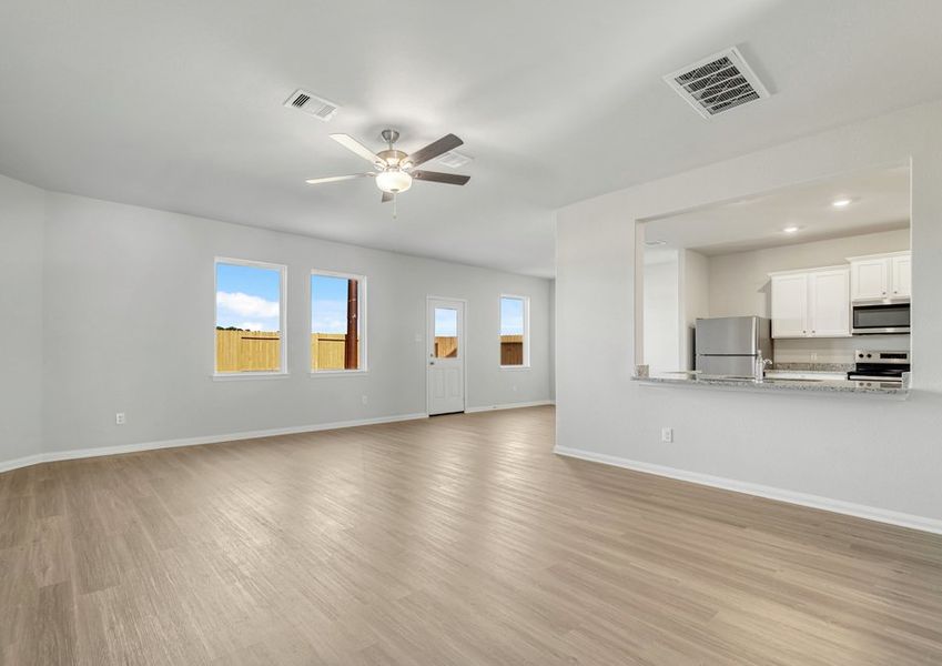 A breakfast bar overlooks the family room