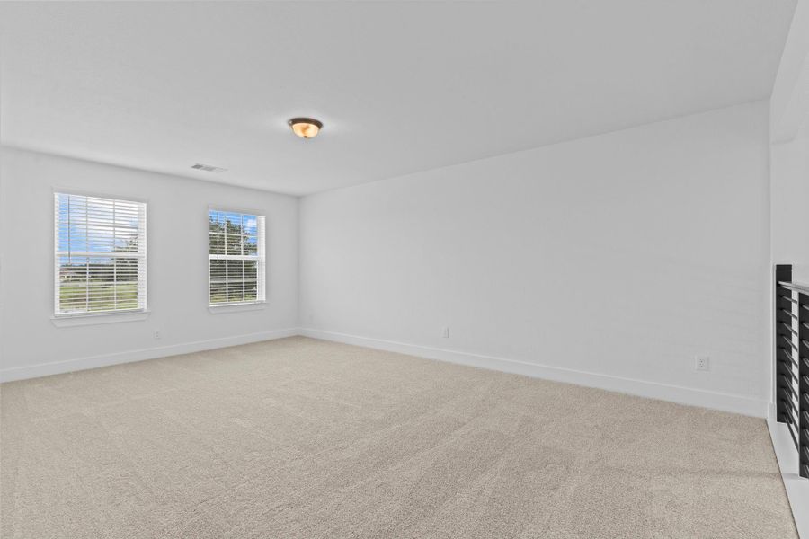 The expansive upstairs game room features plush carpet, natural light from multiple windows, and plenty of space for a media center, play zone, or secondary living area. **Image Representative of Plan Only and May Vary as Built**.