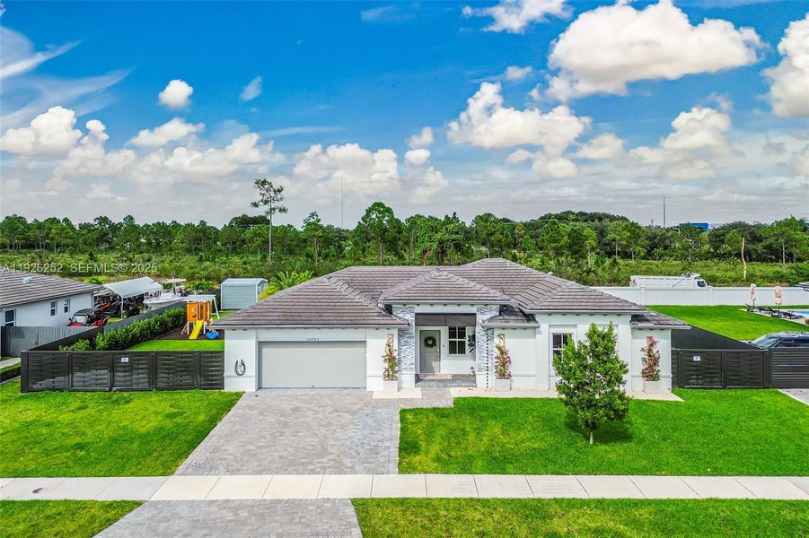Front exterior of a new home in , Homestead, FL, highlighting curb appeal (Image 1).