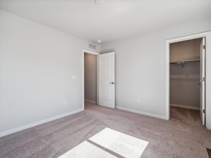 A room with a rug and a door.