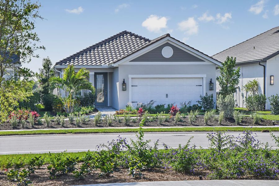 Representative exterior photo of a completed home built from the Dream 2 by Neal Communities in SkySail, Naples, FL (Image 2).