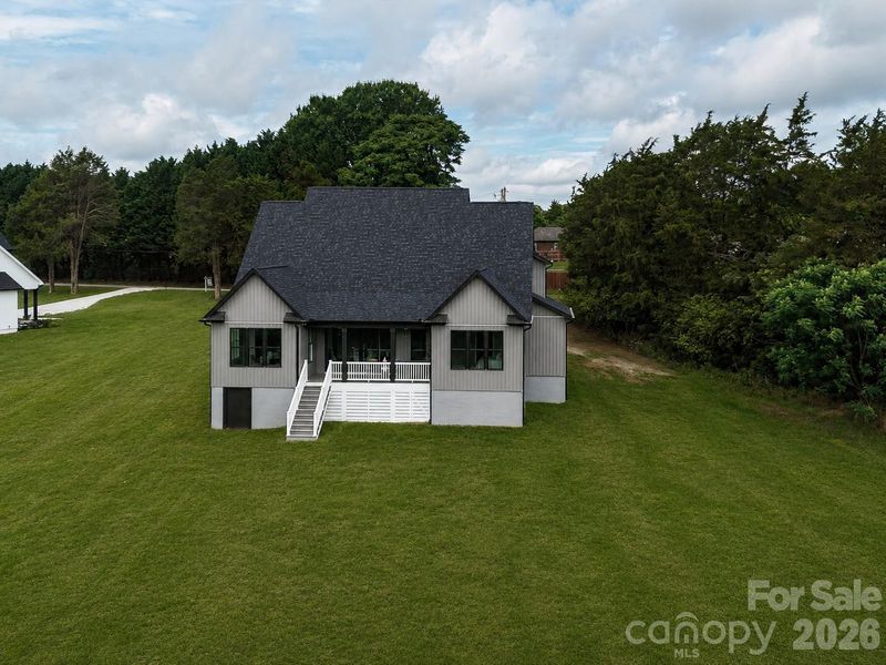 Concept Grass - Enjoy peaceful backyard living with a spacious covered porch, expansive green space, and private tree-lined views perfect for relaxing or entertaining.