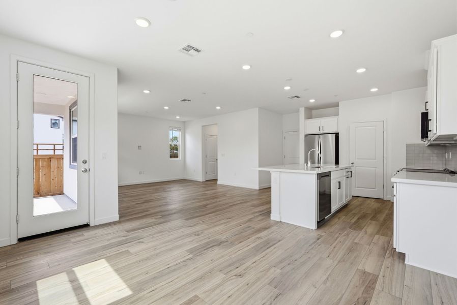 A large kitchen with white cabinets. A large kitchen with white cabinets.