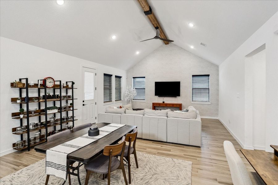The dramatic vaulted ceiling with exposed beam detail creates an airy, custom-home feel rarely found at this price point.