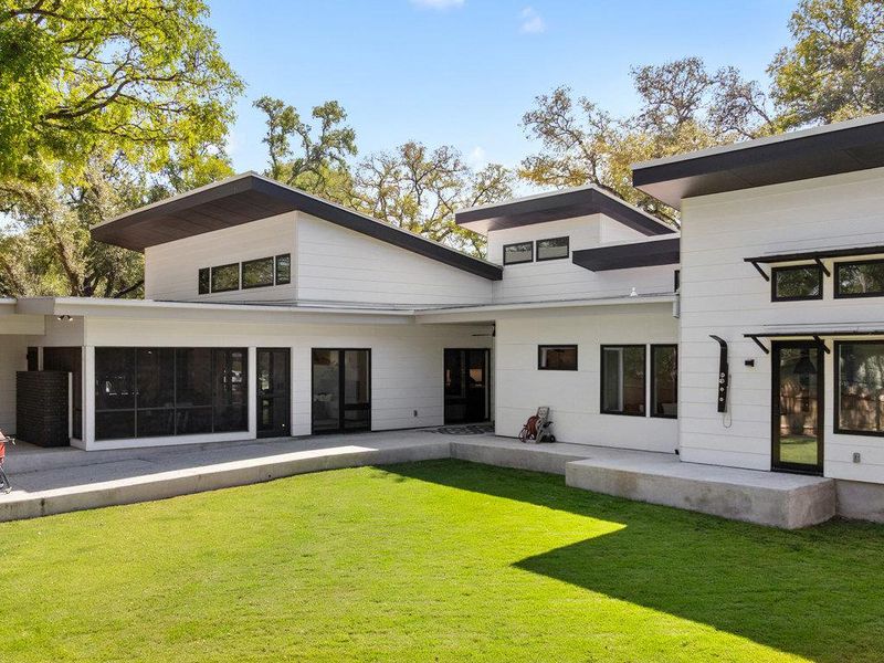 Rear view of house featuring a lawn and a patio area
