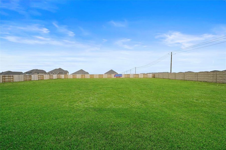 Spacious Backyard with a Masonry Privacy Wall—Perfect for Relaxation and Entertaining