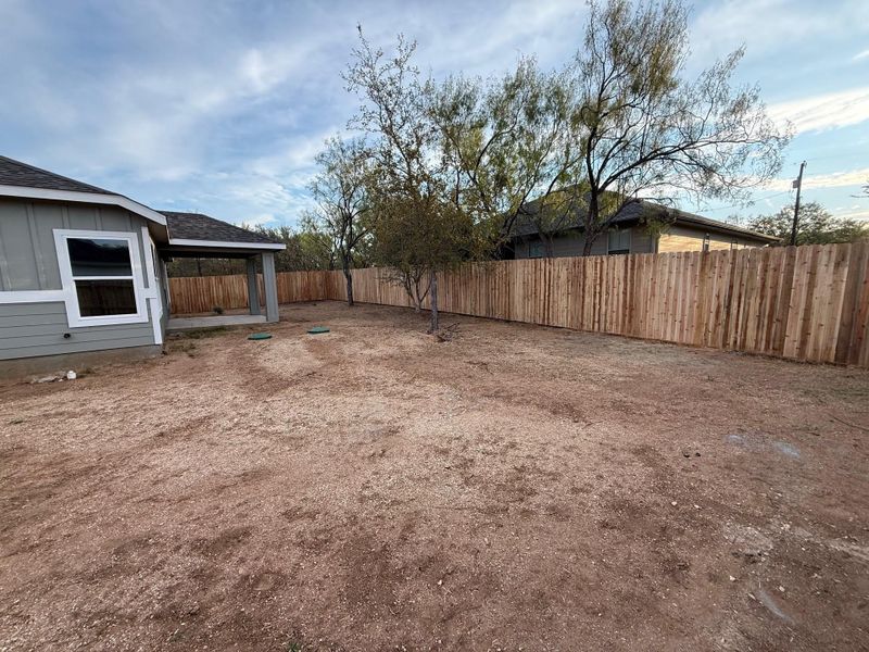 View of fenced backyard