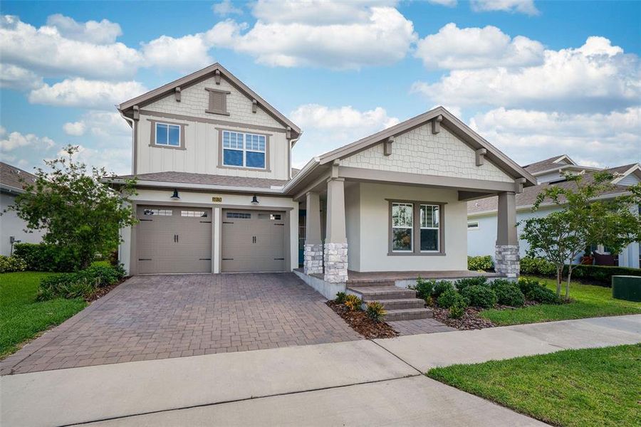 Front exterior of a new home in Laureate Park, Orlando, FL, highlighting curb appeal (Image 25). Front exterior of a new home in Laureate Park, Orlando, FL, highlighting curb appeal (Image 25).