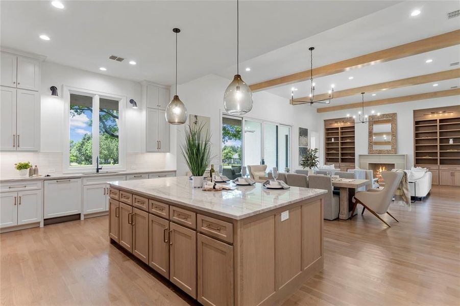 Kitchen and living room take advantage of the beautiful backyard space.