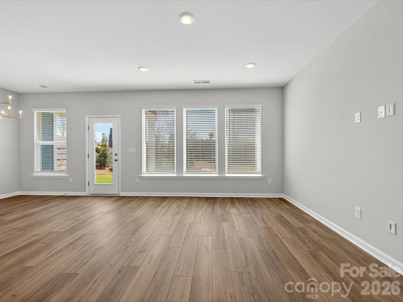 Open, bright living room with LVP flooring