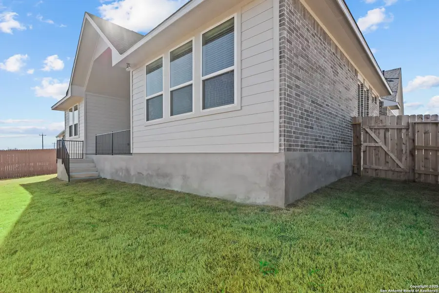 Exterior details and patio area of a home in Potranco Oaks, Castroville (Image 1).