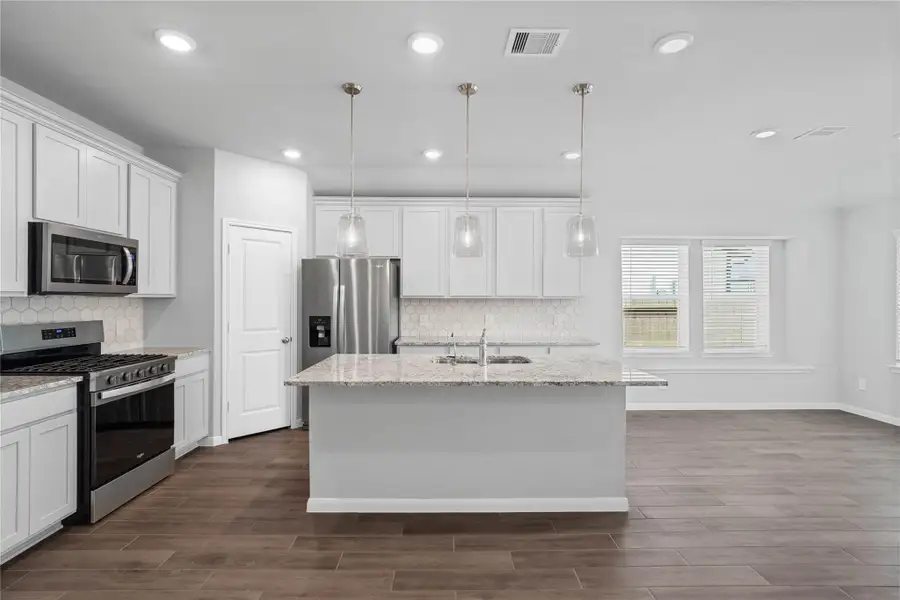 The spacious kitchen and dining combination keeps everyone connected while offering a large center island, abundant cabinetry, and a bright breakfast nook for seamless everyday living and entertaining.