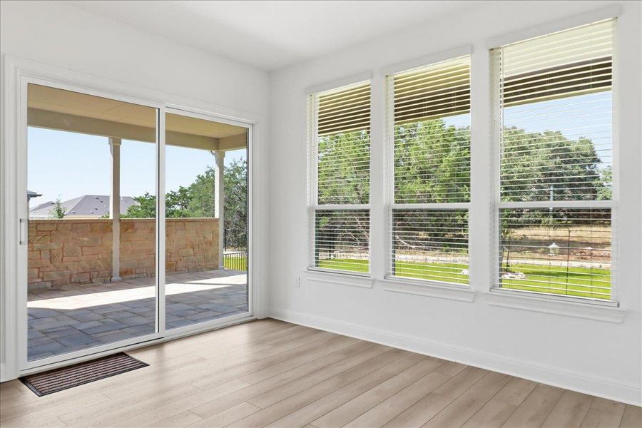 Sliding glass doors open to an inviting outdoor patio space, offering tranquil views of the verdant surroundings. Sliding glass doors open to an inviting outdoor patio space, offering tranquil views of the verdant surroundings.