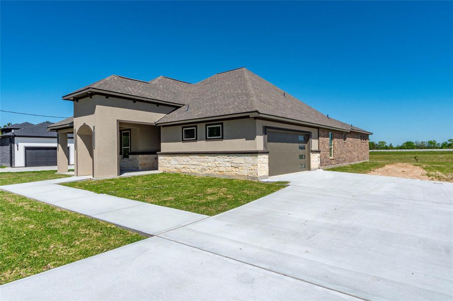Front exterior of a new home in , Dayton, TX, highlighting curb appeal (Image 2). Front exterior of a new home in , Dayton, TX, highlighting curb appeal (Image 2).
