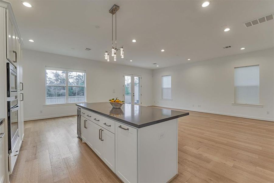 Expansive block island with island seating, beverage chiller, and trash storage! This open great room was made for entertaining!