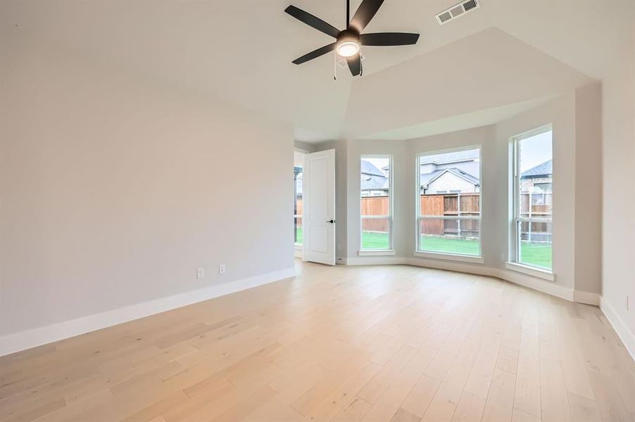 Spare room with ceiling fan and light wood-type flooring