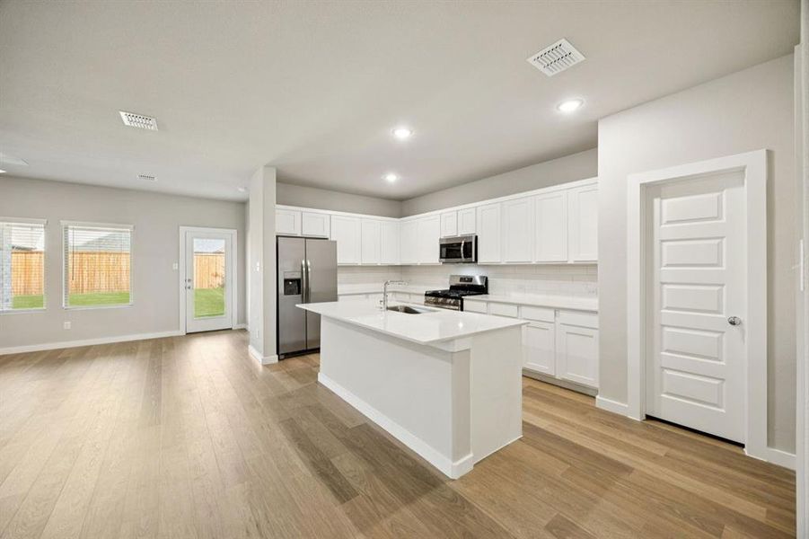 Kitchen in the Oscar home plan by Trophy Signature Homes – REPRESENTATIVE PHOTO