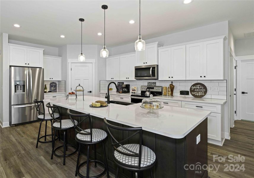 Dream Kitchen with 10 foot quartz island & stainless appliances.