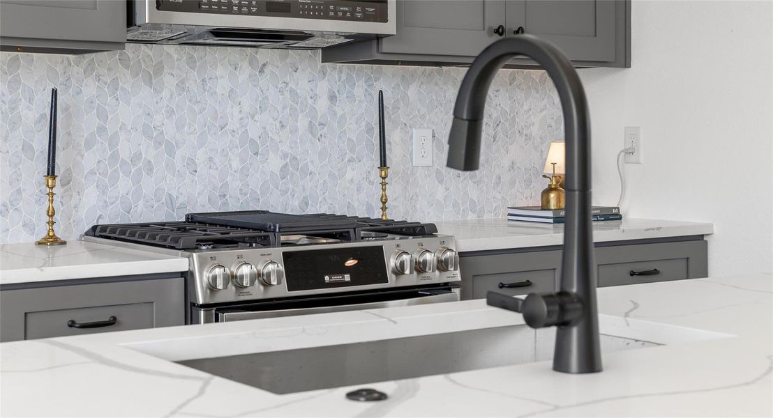 A chef-ready kitchen with a gas range and tile backsplash — the kind of space that makes cooking at home a joy. Model No. 105 Shown.