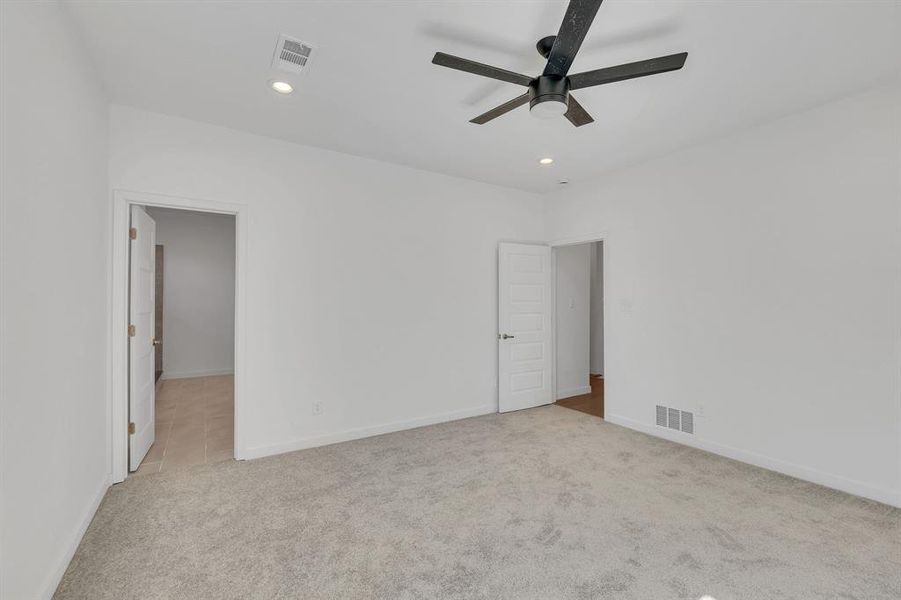 Empty room featuring light carpet, recessed lighting, and ceiling fan