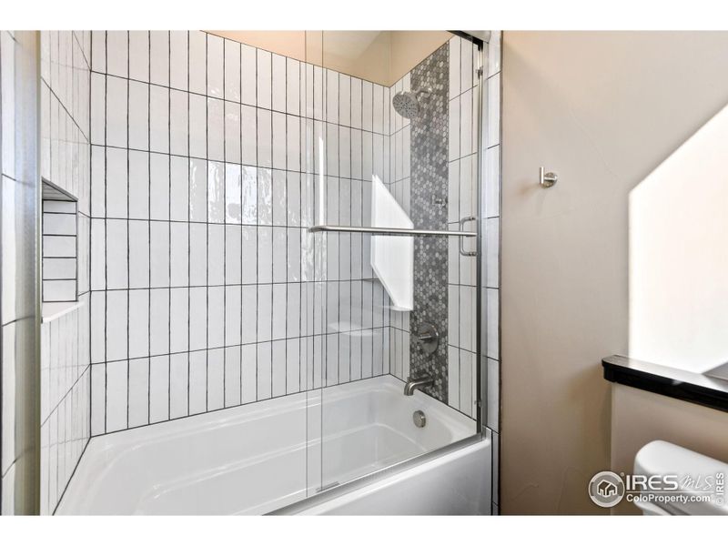 Main level shared full bath is stylish and comfortable with those heated floors!