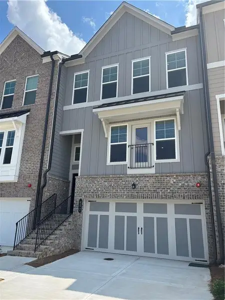 Front exterior of a new home in Forrest Crossing, Woodstock, GA, highlighting curb appeal (Image 1). Front exterior of a new home in Forrest Crossing, Woodstock, GA, highlighting curb appeal (Image 1).