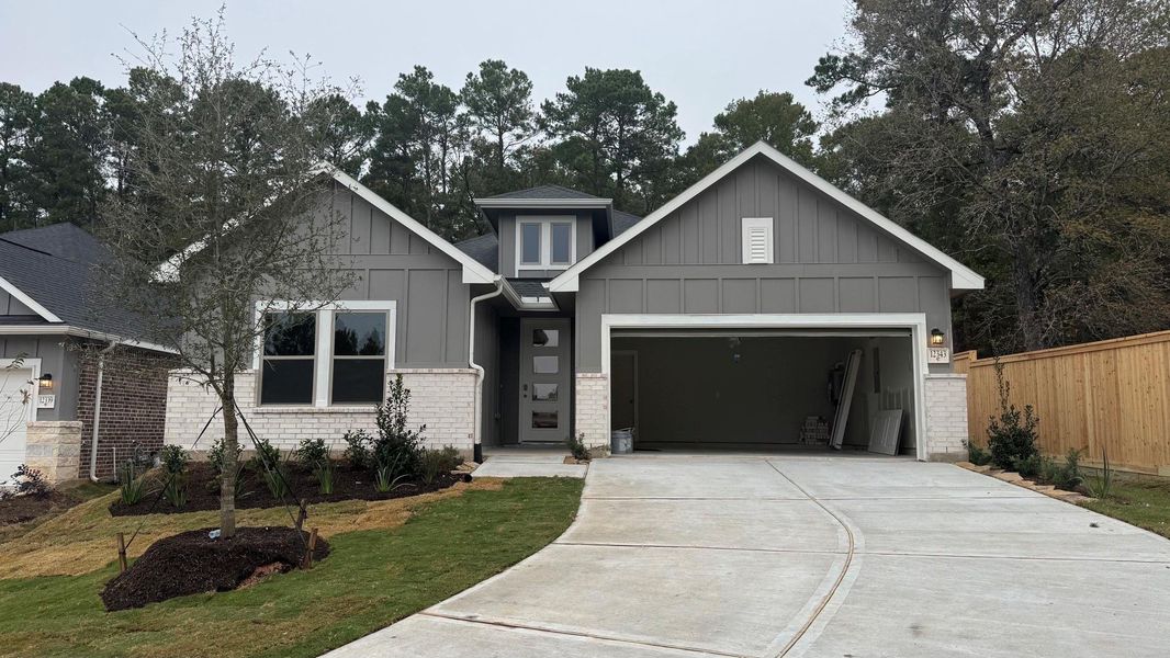 Front exterior of a new home in Westridge Cove, Conroe, TX, highlighting curb appeal (Image 1).