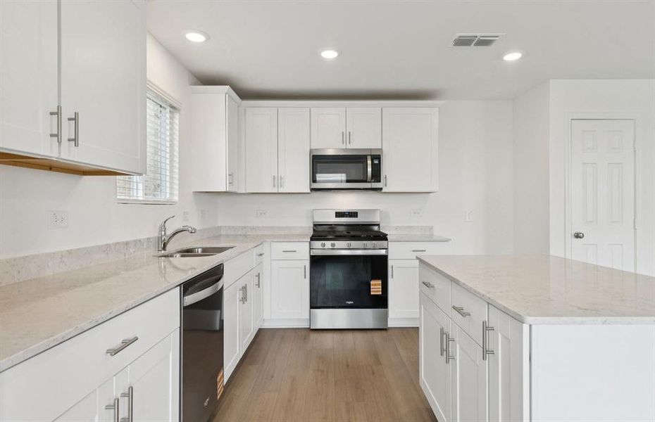 Spacious kitchen with eat-in bartop island