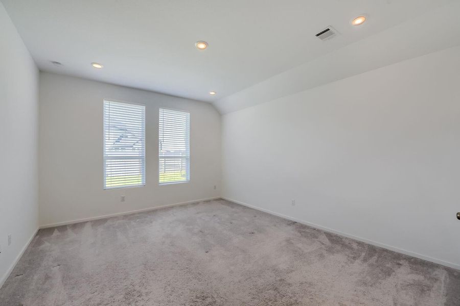 The primary bedroom offers a private retreat at the rear of the home.