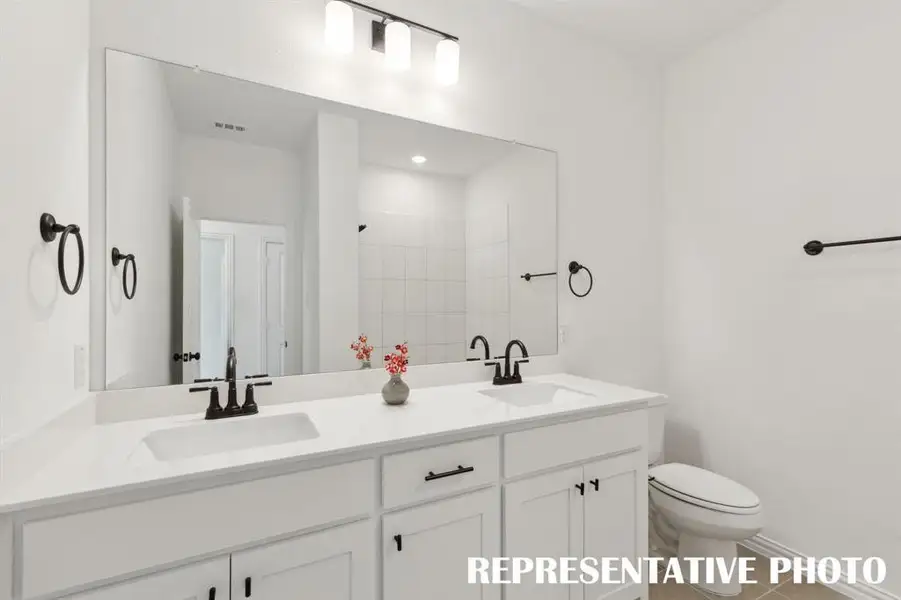 Guests will enjoy their own vanity space in this lovely guest bath.  REPRESENTATIVE PHOTO