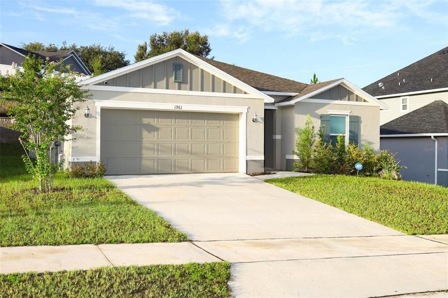 Front exterior of a new home in The Reserve at Lake Ridge II, Minneola, FL, highlighting curb appeal (Image 20).