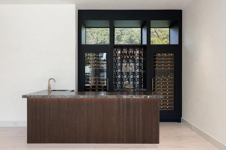 Wine cellar with bar with sink and beverage cooler