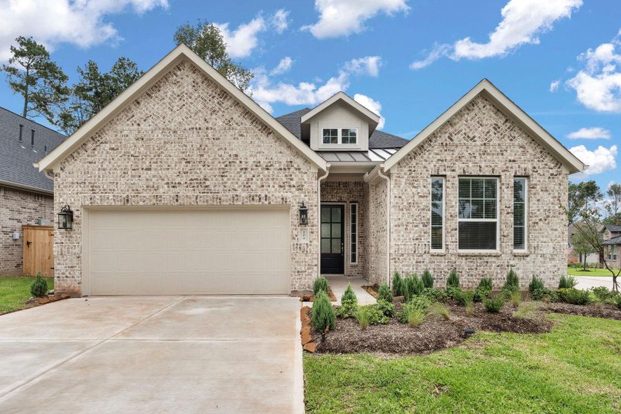 Front exterior of a new home in The Woodlands Hills, Willis, TX, highlighting curb appeal (Image 2).