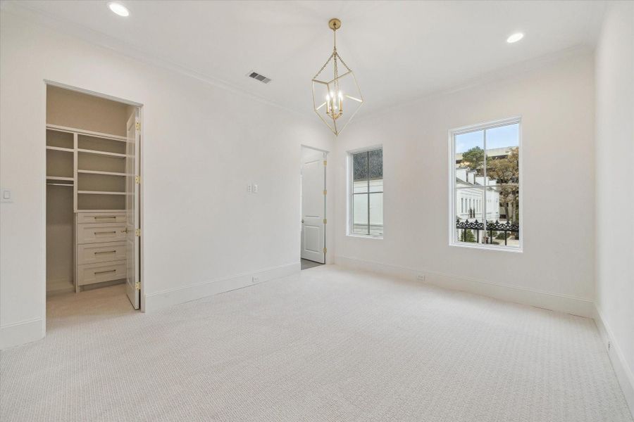 The first of the second-floor bedrooms features Shaw carpet in the color pearl, en-suite bathroom, spaciouswalk-in closet.