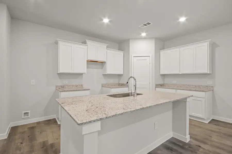 A kitchen with white cabinets. A kitchen with white cabinets.