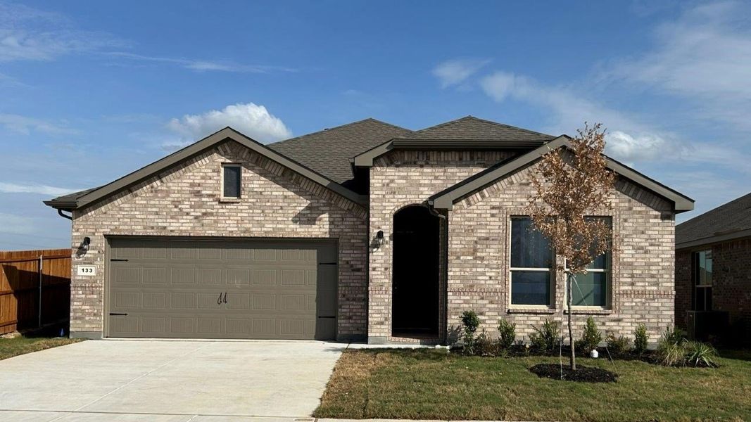 Front exterior of a new home in Bluestem, Rhome, TX, highlighting curb appeal (Image 1). Front exterior of a new home in Bluestem, Rhome, TX, highlighting curb appeal (Image 1).