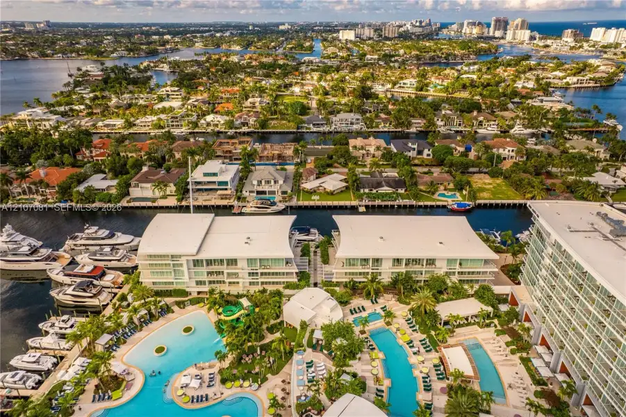 Waterfront complex featuring deep-water boat slips, multi-level swimming pools, manicured tropical landscaping, and expansive exterior balconies Waterfront complex featuring deep-water boat slips, multi-level swimming pools, manicured tropical landscaping, and expansive exterior balconies