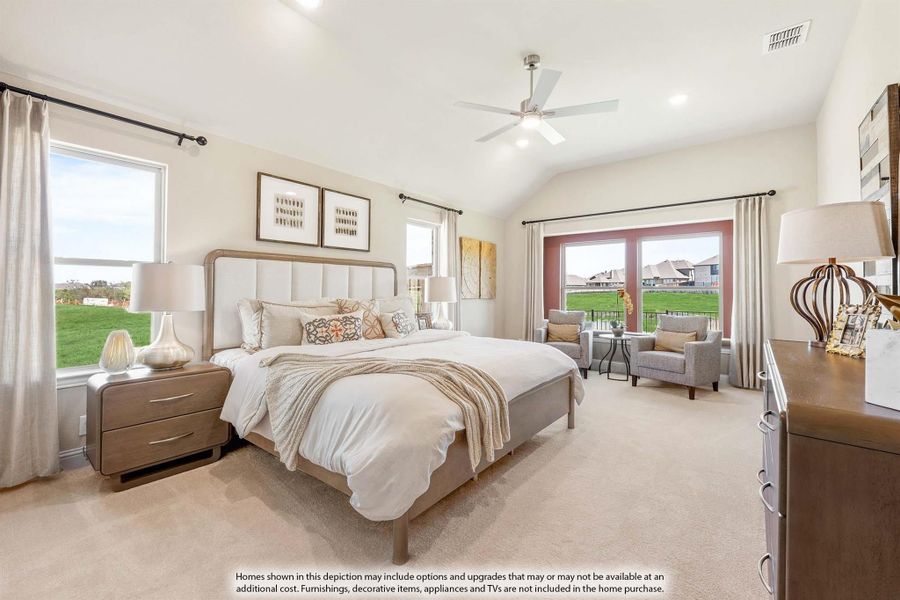 Master bedroom with vaulted ceiling, ceiling fan, carpet flooring, and French doors leading to a balcony seating area.