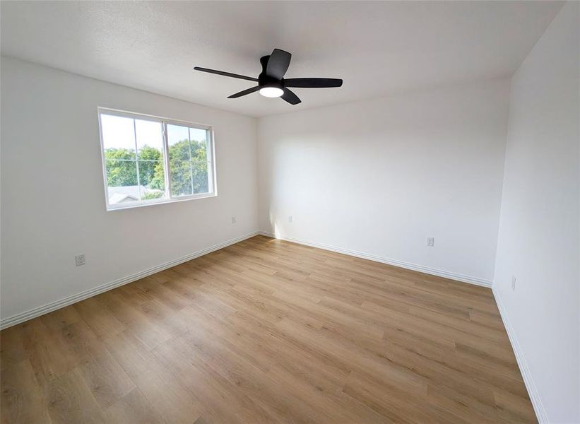 Spare room with ceiling fan and light hardwood / wood-style floors