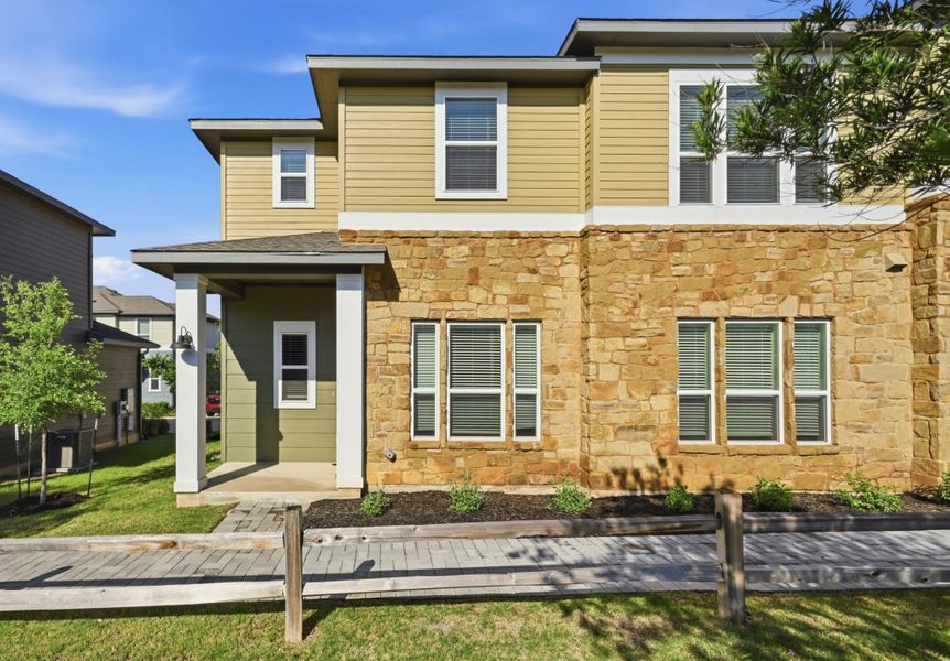 Two-story residence featuring a stone and siding exterior Two-story residence featuring a stone and siding exterior