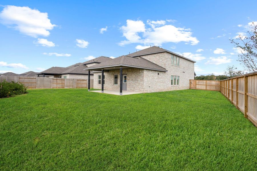 A view of the expansive backyard highlights the size and privacy of this corner lot — an ideal canvas for play, pets, or future outdoor enhancements.